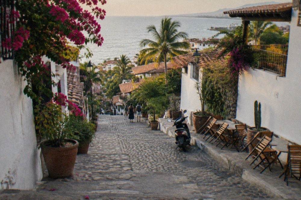 Cobblestone street in Zona Romantica lined with restaurant tables in the late afternoon
