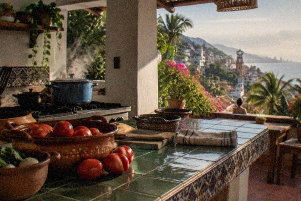 A home kitchen counter with clay cookware, fresh chiles, tomatoes, and tortillas laid out for a cooking lesson