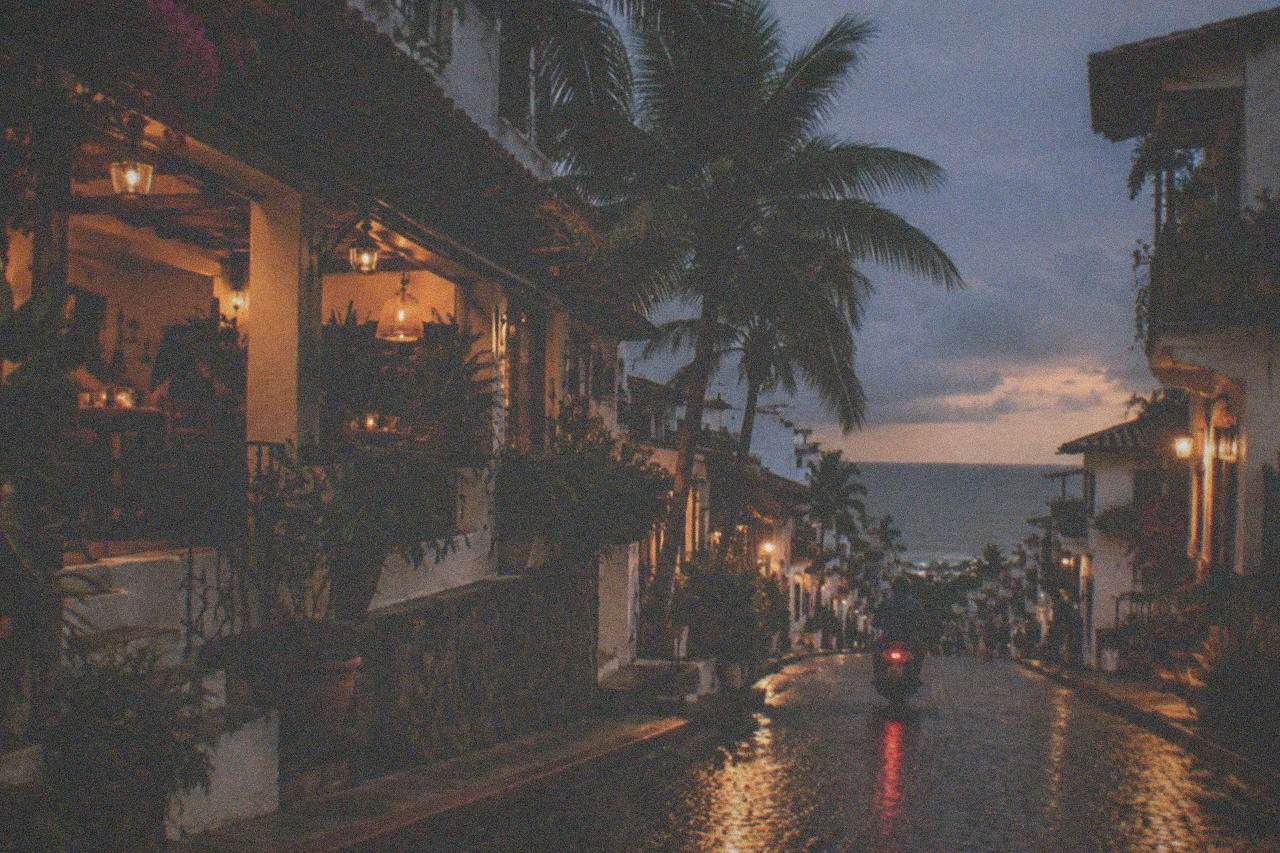 Cobblestone street in Zona Romantica with restaurants and string lights in the evening