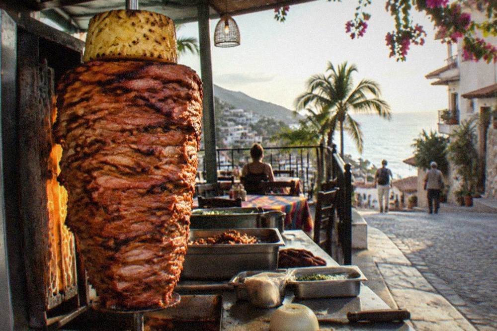 Street taco stand with trompo spit and stacked pineapple under warm evening light