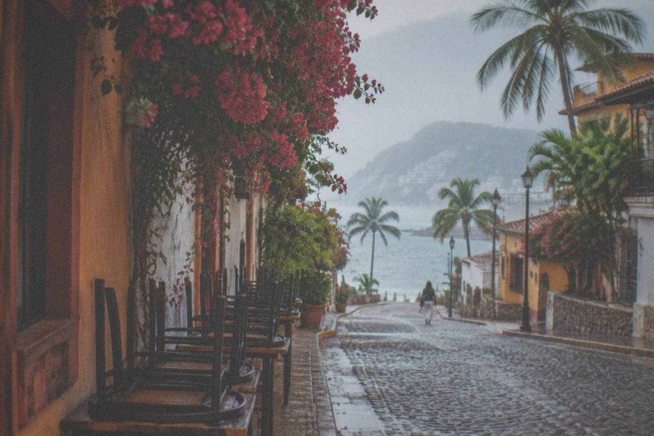 Cobblestone street in Zona Romantica lined with cafe tables and colorful building facades
