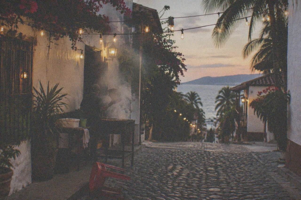 Evening view of a Puerto Vallarta street with taco stands and string lights