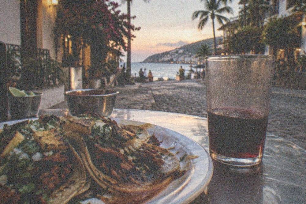Close view of al pastor tacos with pineapple and cilantro on corn tortillas