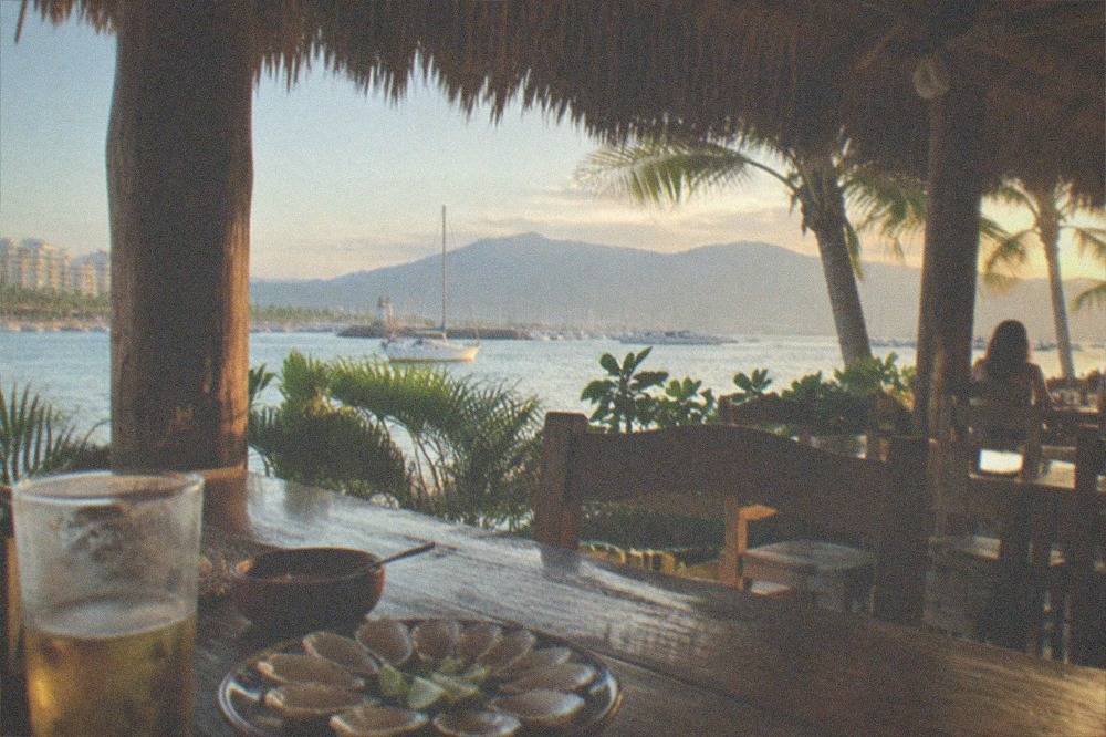 Beachfront palapa restaurant with open sides overlooking the bay